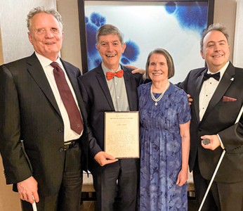 Group photo captured at the 2023 NFB National Convention, featuring Gilles Pepin proudly holding his well-deserved award joined by Dr. Marc Maurer, past NFB President, Mary Ellen Jernigan, the wife of the late Kenneth Jernigan, and Mark Riccobono, the current President of the NFB.