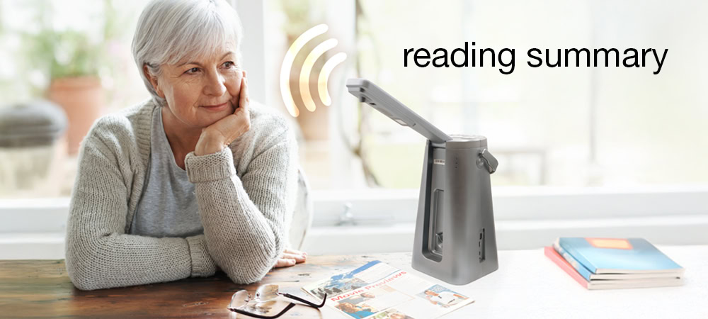 Image of a pensive elderly woman listening with interest as the Odyssey provides a reading summary, while magazines and books are scattered around her.