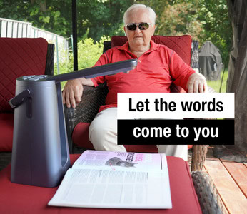 An elderly man relaxes while listening to the Odyssey voice reading his favorite magazine.