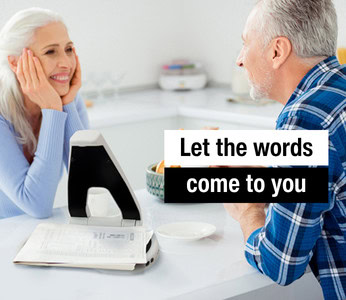 An elderly couple shares a joyful moment in the kitchen, over breakfast. Their newspaper is placed on the of the Hark.