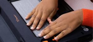 Woman working with Monarch at a desk, focused on his task.