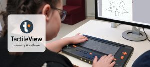 A student interacts with the Monarch’s touchscreen, which displays a tree. The same image also appears on a computer screen.