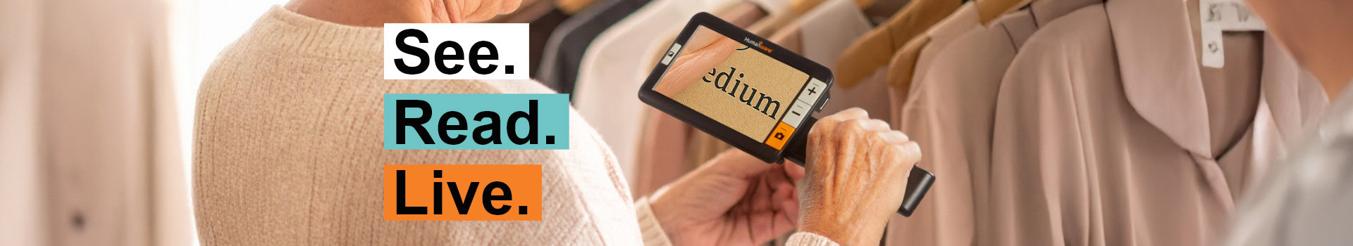 Person using a portable digital magnifier to read the size label "medium" on a garment in a store, with the text "See. Read. Live."