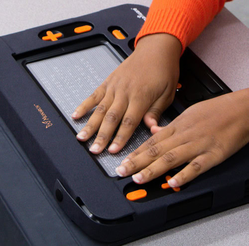A student explores the world of tactile braille with HumanWare’s Monarch.