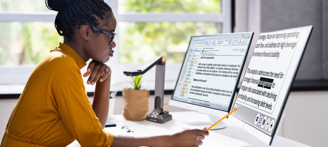 Woman reviewing text on a computer using Prodigi AI Assistant.