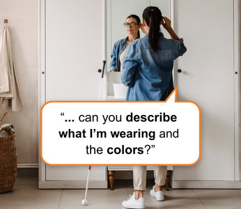A blind woman stands in front of a mirror, touching the frame of her smart glasses.