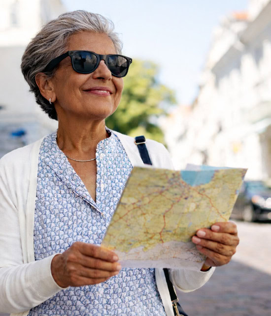 Older woman wearing Ray-Ban Meta glasses, looking at a map on a sunny cobblestone street. Older woman wearing Ray-Ban Meta glasses, looking at a map on a sunny cobblestone street.