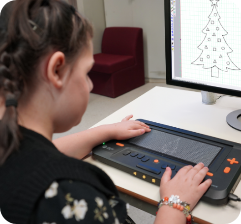 Student uses a Monarch braille display with a drawing on screen.
