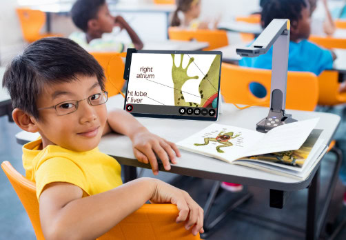 Student using a magnification device to view a diagram in class.