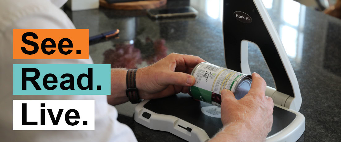 Man scanning a can with a reading machine, text “See. Read. Live.”