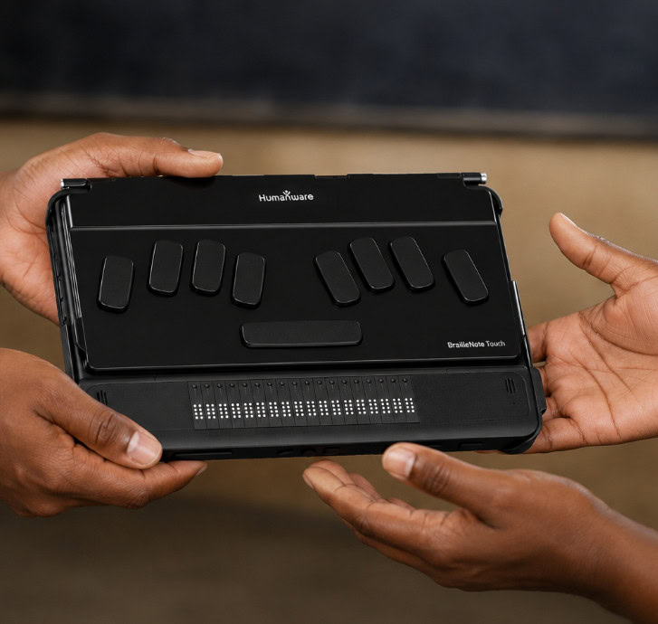 Hands holding a BrailleNote Touch Plus.